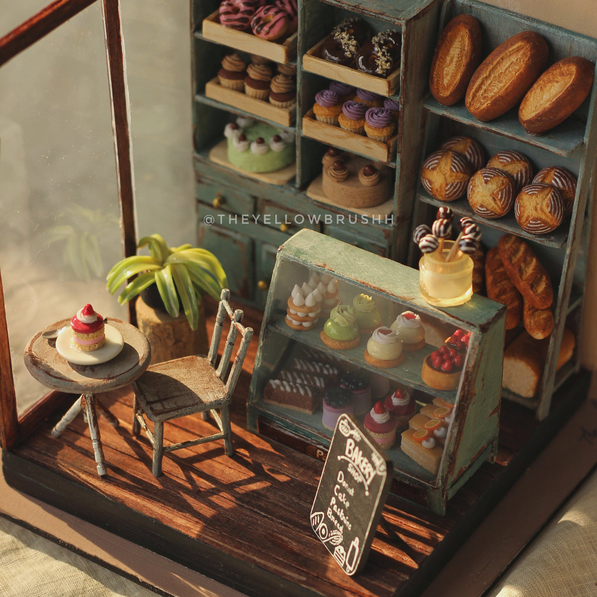 Bakery collection display with pastries and miniature café setup