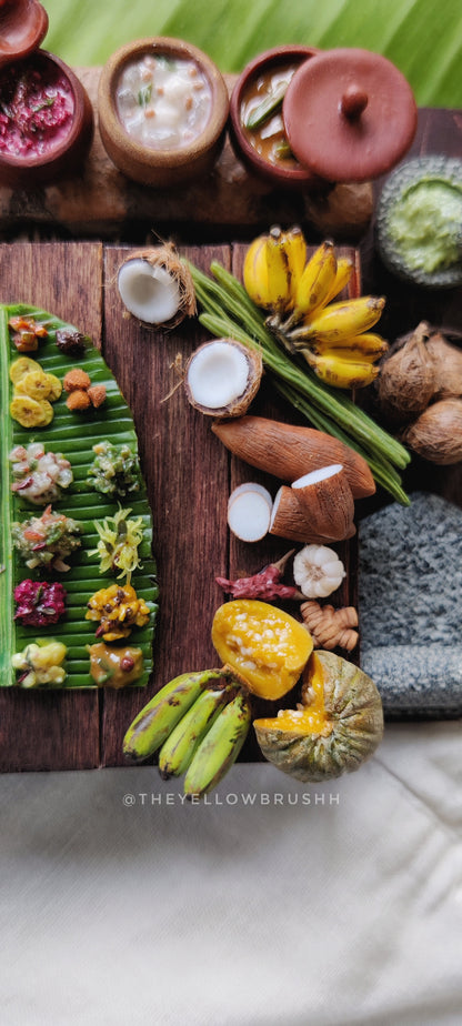 Close-up of miniature Onam-inspired festive food display with bowls and utensils